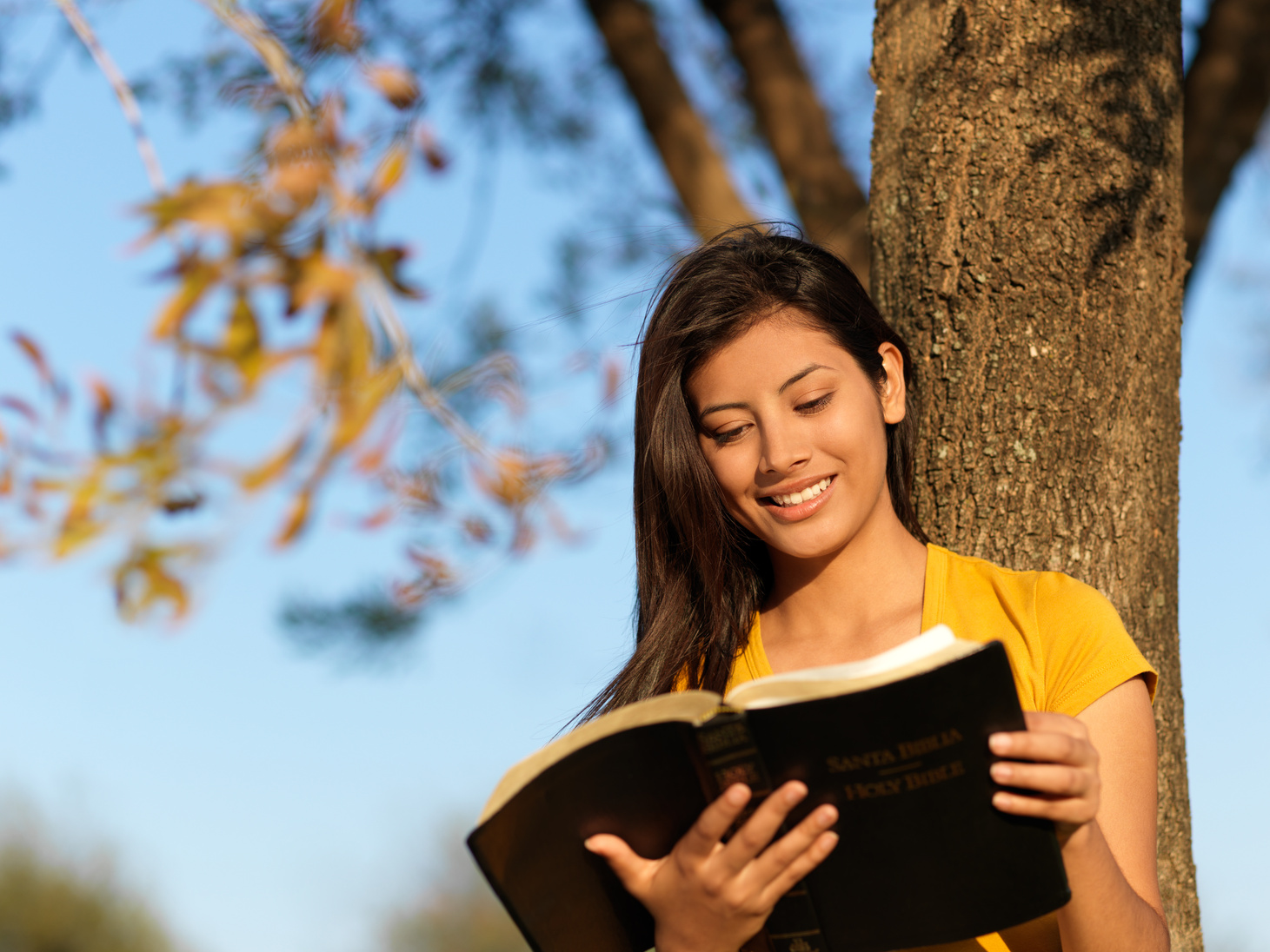 Latin teenager reading the Bible